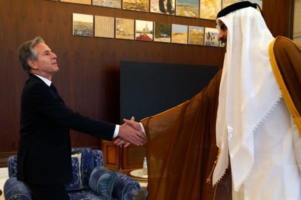 U.S. Secretary of State Antony Blinken, left, and Qatari Emir Sheikh Tamim bin Hamad Al Thani shake hands before their meeting in Lusail, Qatar, Friday Oct. 13, 2023.